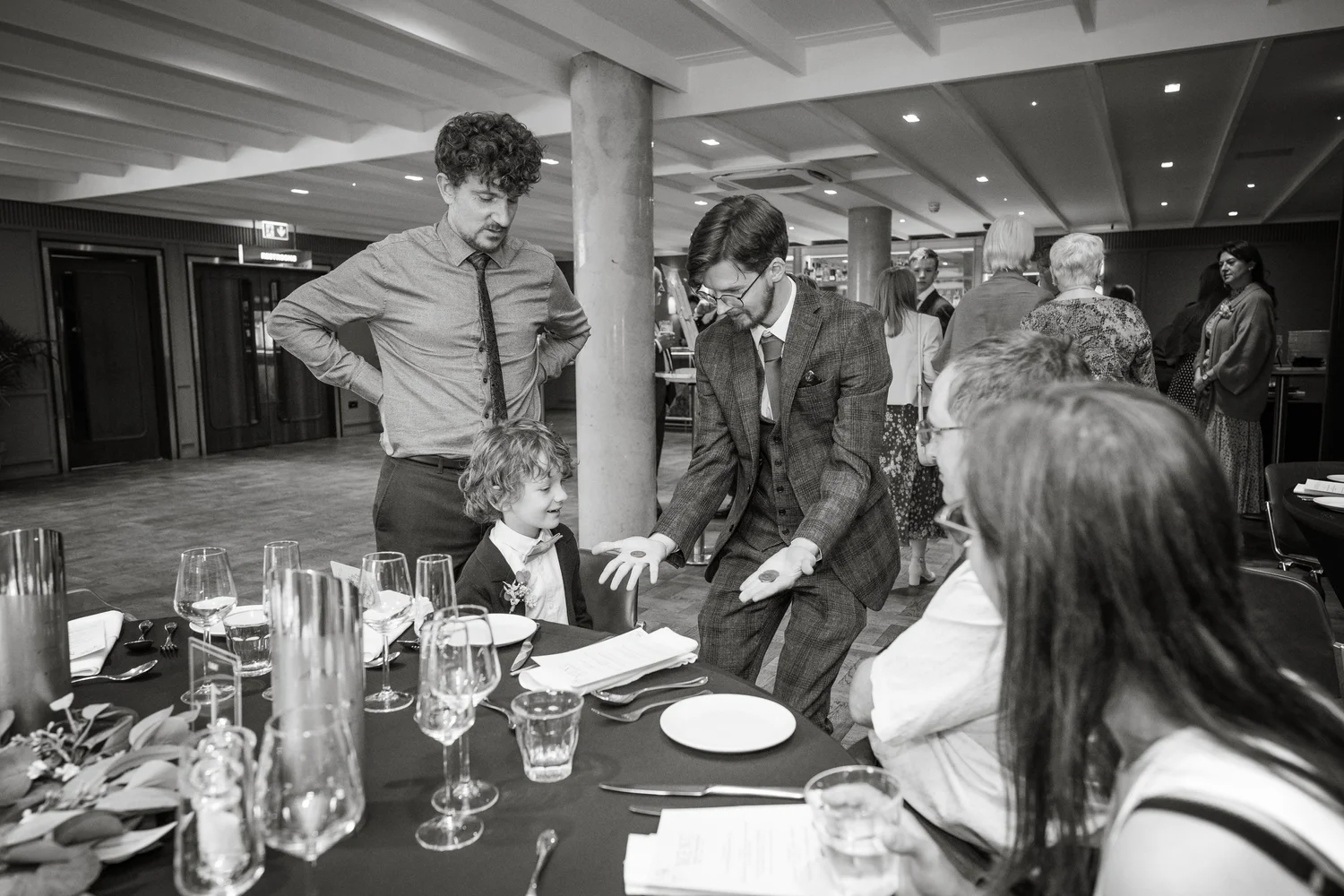 Zac performing close-up magic for an audience